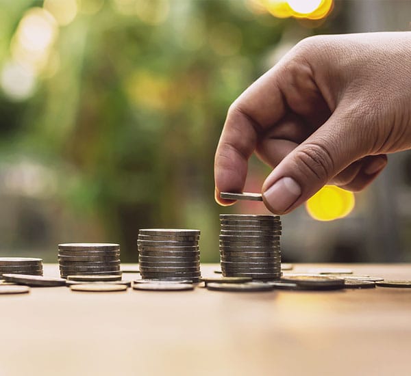 person stacking coins