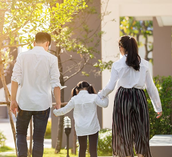 family walking down a sidewalk